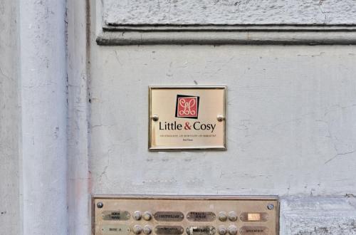 a sign on the side of a building at LittleAndCosy in Turin