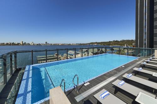 a swimming pool on top of a building at Doubletree By Hilton Perth Waterfront in Perth
