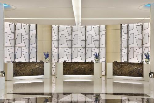 a lobby with two displays in front of a wall at Hilton Dubai Palm Jumeirah in Dubai
