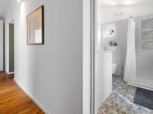 a white bathroom with a toilet and a mirror at El Dorado in Premantura