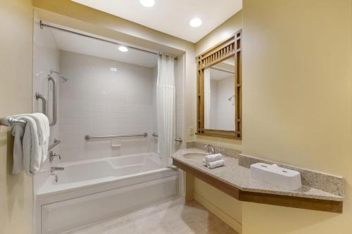 a bathroom with a bath tub and a sink at Hilton Vacation Club Cancun Resort Las Vegas in Las Vegas