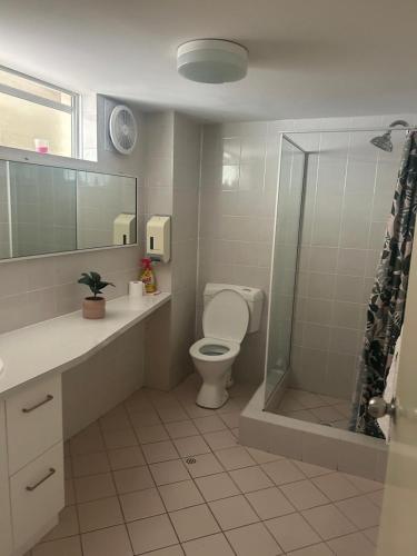 a bathroom with a toilet and a shower at Manduhra Motel Resort in Mandurah