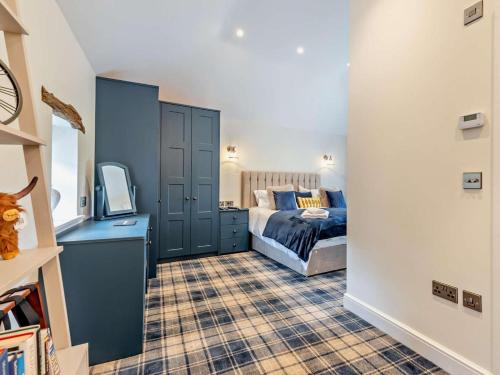 a bedroom with a bed and a blue cabinet at 1 Bed in Carlisle oc-94538 in Scaleby