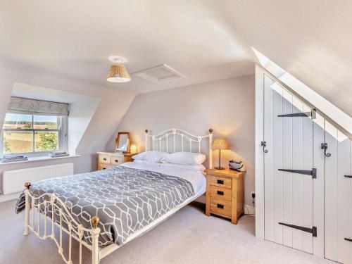 a bedroom with a white bed and a window at 4 Bed in Chathill oc-93702 in Ellingham