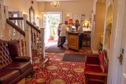 a group of people standing in a hallway at Haddon House Hotel in Bridport