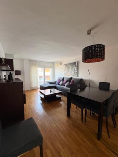 a living room with a couch and a table in it at Dalí City Apartamento in Figueres