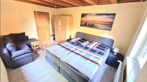 a bedroom with a bed and a couch at Staar in Hohenfelde