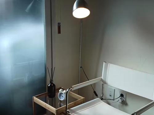 a bathroom with a mirror and a sink and a lamp at Fresh Stay in Seoul