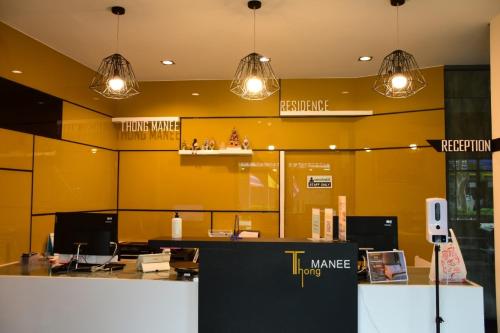 a store with yellow walls and pendant lights at Thongmanee Hotel in Hat Yai