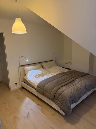 a bedroom with a bed in a room with a ceiling at Cosy Seahouse in Knokke-Heist