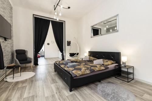 a bedroom with a bed and a chair at Wellnes apartmán Leqwell in Uherský Brod