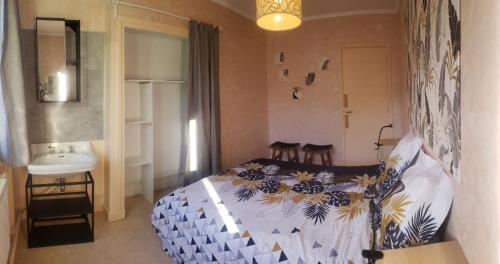 a bedroom with a bed and a sink in it at La Villa Pauze in Royat