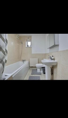 a bathroom with a sink and a tub and a toilet at Flat in Portsmouth in Portsmouth