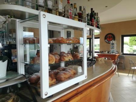 a display case in a bakery with donuts at I Settembrini in Capo Vaticano