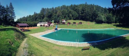 an aerial view of a swimming pool in a field at Chatka Agawa v areálu Koupaliště Bystré v Orlických horách in Bystré