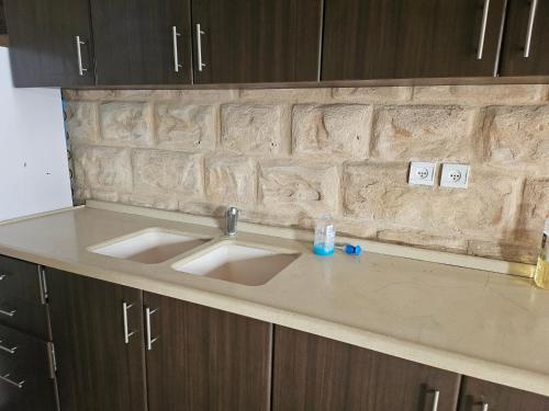 a kitchen counter top with two sinks in it at בית האומן in Safed