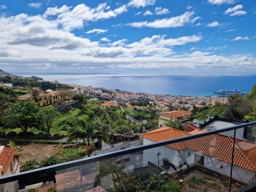 a view of the ocean from the balcony of a house at CoLiving Funchal in Funchal
