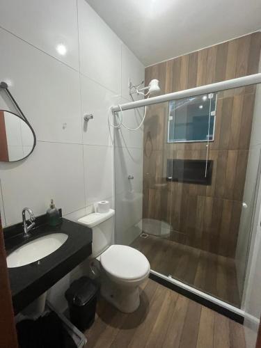a bathroom with a shower and a toilet and a sink at Casa de Praia no Condomínio Florestinha com 02 quartos in Tamoios