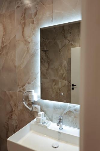 a bathroom with a sink and a mirror at Zoe Boutique Hotel in Durrës