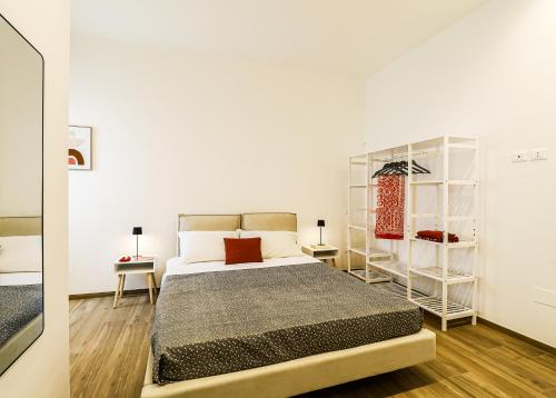 a bedroom with a bed and a book shelf at Umberto I by Casa di Marco in Sannicola