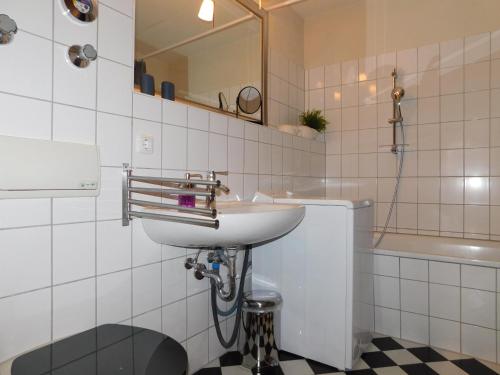 a bathroom with a sink and a toilet and a tub at Boje Haus Sanddorn in Althagen
