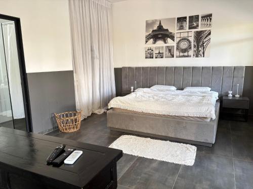 a bedroom with a large bed and a table at Aharon boutique suite in Pardes H̱anna