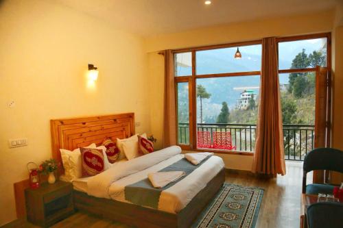 a bedroom with a bed and a large window at North star Manali in Vashisht