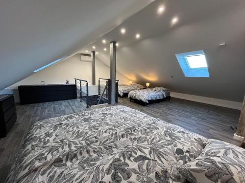 a large bedroom with a large bed and a window at Le Chalet de la belle vue in Fouchy