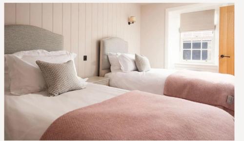 a hotel room with two beds and a window at Hoolet's View, East Lothian in Whittingehame