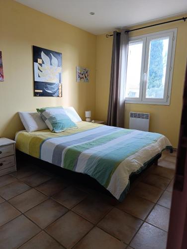 a bedroom with a large bed with a window at La bastide 4 chambres in Artignosc-sur-Verdon