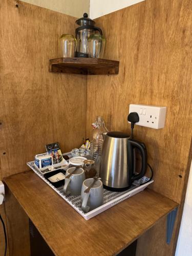 a kitchen counter with a tea pot on a tray at Tanglin Guest House in Oban
