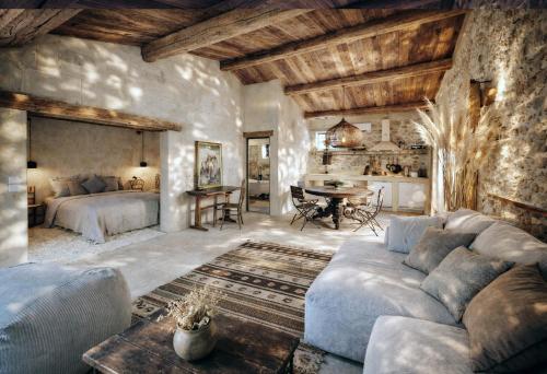 a large living room with a couch and a table at Moulin des Bergères in Mouriès
