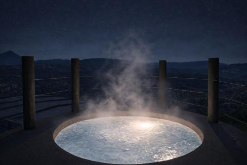 a bath tub with steam coming out of it at night at Casa Zúrich in La Estación