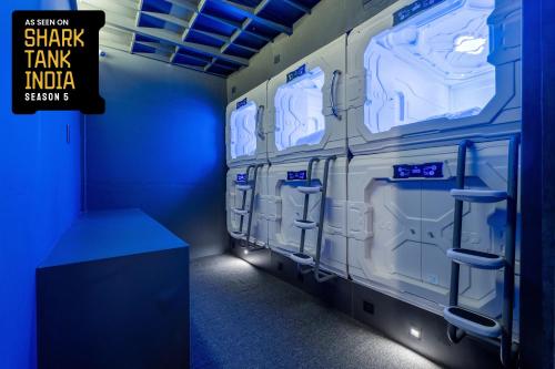 a row of lockers in a blue room at NapTapGo - Japanese Premium POD Hotel - Walk to Noida Electronic City Metro! Wifi, Lounge in Noida