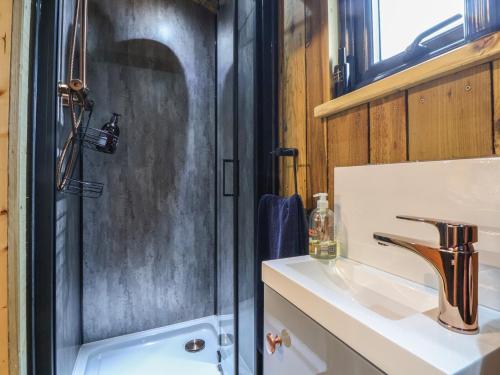 a bathroom with a sink and a shower at The Suffolk Hut in Knutsford
