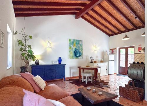 a living room with a couch and a table at Milharadas - A Private Oasis in the Alentejo in Odemira