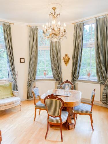 a dining room with a table and chairs and windows at Hotel Rotdorn in Berlin
