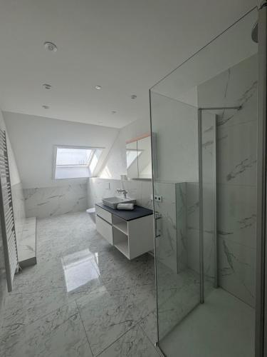 a bathroom with a glass shower and a sink at Gestüt Kaiserhof in Legelshurst