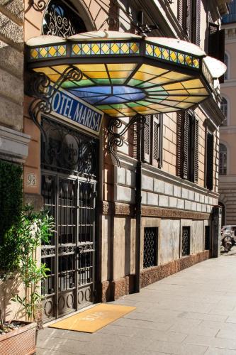 a building with a store entrance with a sign on it at Hotel Marisa in Rome