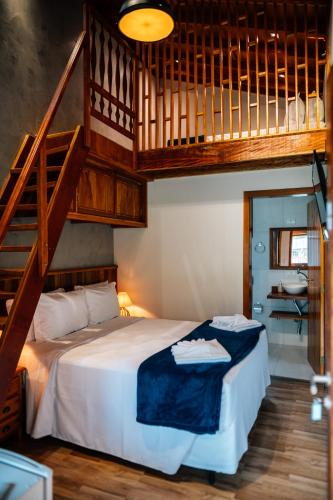 a bedroom with a large bed with a staircase at Espaço Villa Verde in Ibiúna