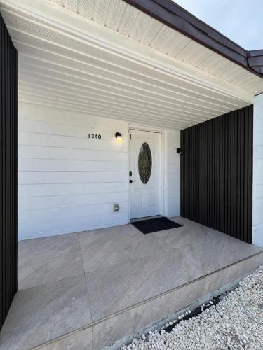 a white garage with a white door and a white door at Cozy Guesthouse Downtown Tampa in Tampa