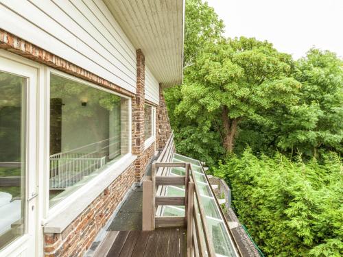 a porch of a house with a wooden deck at Luxury Villa with Sauna and bubble bath in Middelkerke