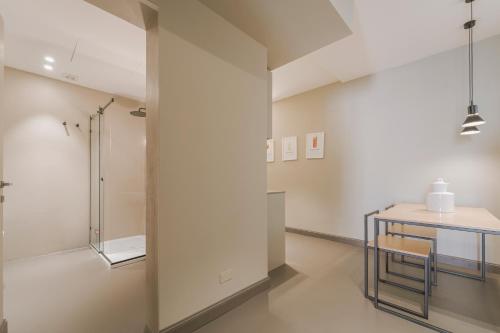 a bathroom with a table and a shower at Torrearsa street 35 in Trapani