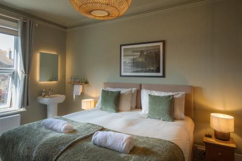 a bedroom with a bed with two pillows on it at The Albany Rooms Bexhill in Bexhill