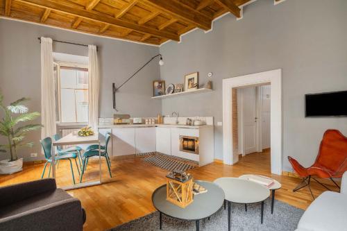 a living room with a couch and tables and a fireplace at Campo de Fiori Bright Apartment in Rome