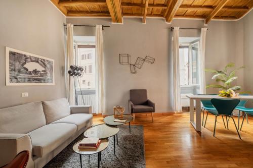 a living room with a couch and a table at Campo de Fiori Bright Apartment in Rome