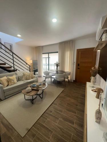 a living room with a couch and a table at Luxury Penthouse, Pool, Bbq, Private Terrace in Pueblo Bavaro