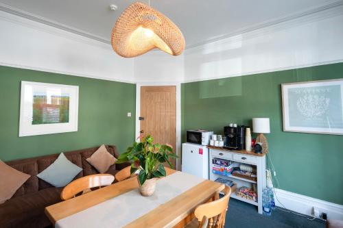 a living room with a table and a couch at The Albany Rooms Bexhill in Bexhill