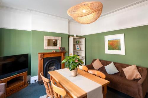 a living room with a couch and a table at The Albany Rooms Bexhill in Bexhill