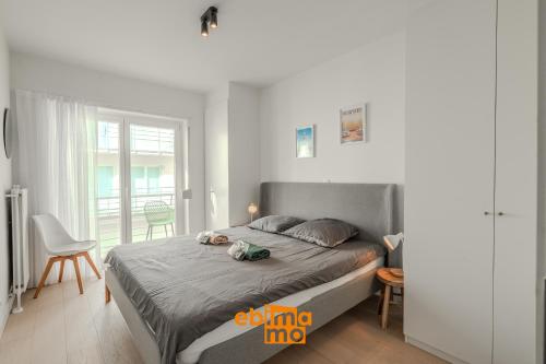 a bedroom with a bed and a table and chairs at Velasquez 0303 in Nieuwpoort